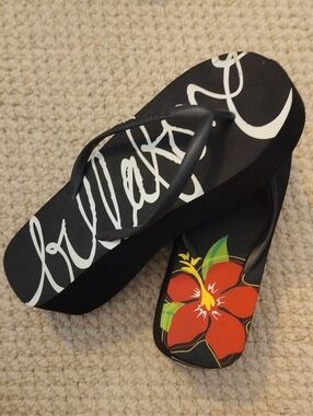 Billabong Black Wedge Flip Flops with Red Floral Accent.